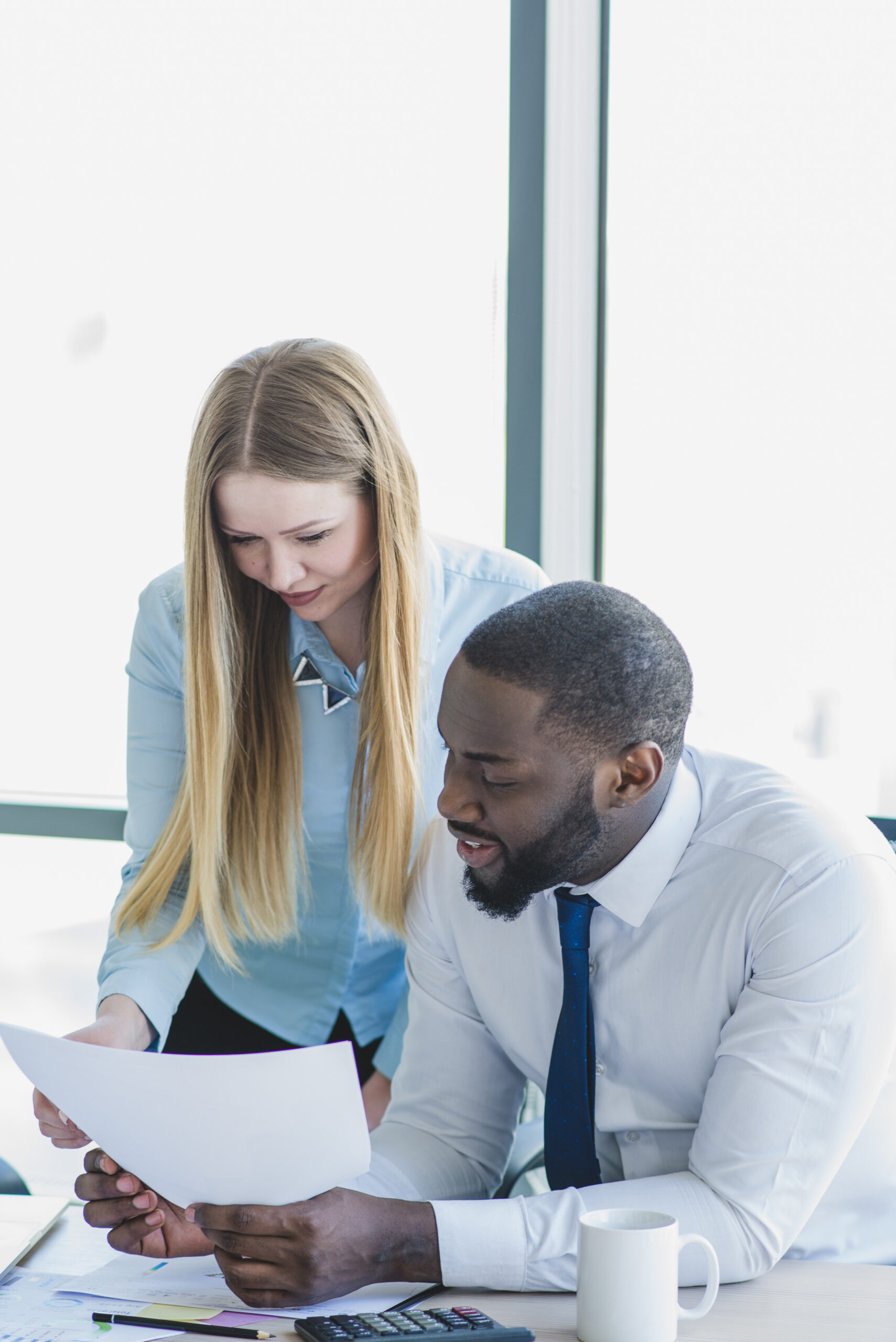 Man woman reading business paper