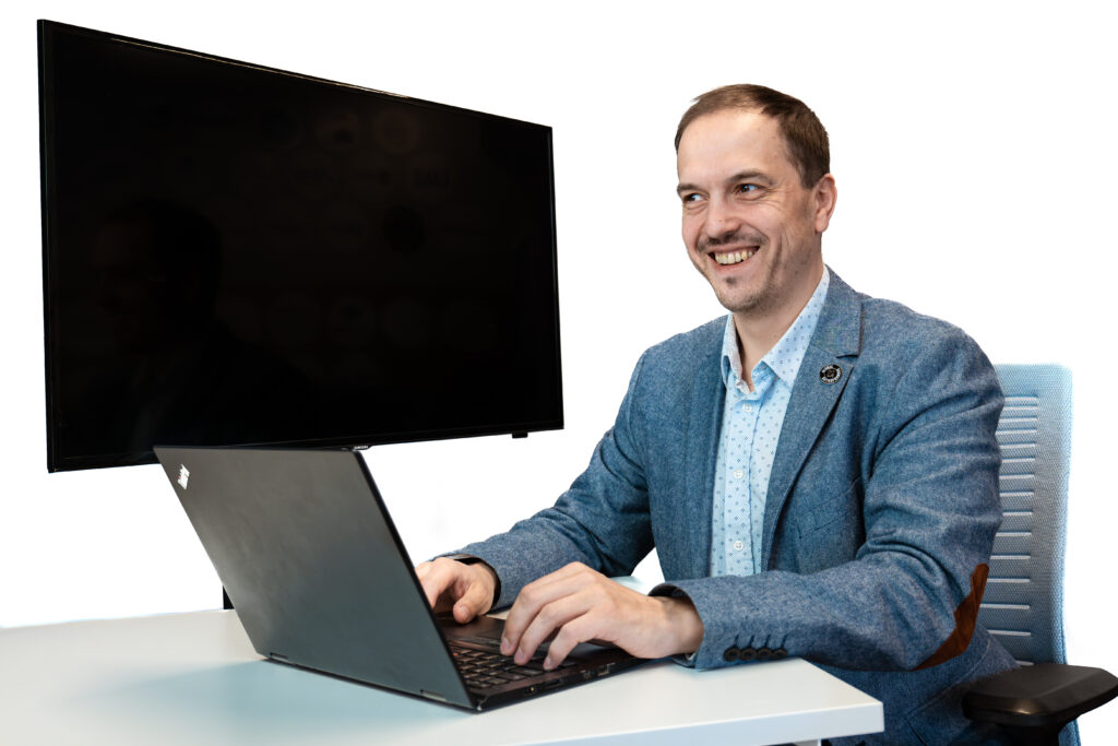 alex in an office using a computer, attempting to code